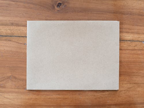 Brown Envelope on Wooden Table