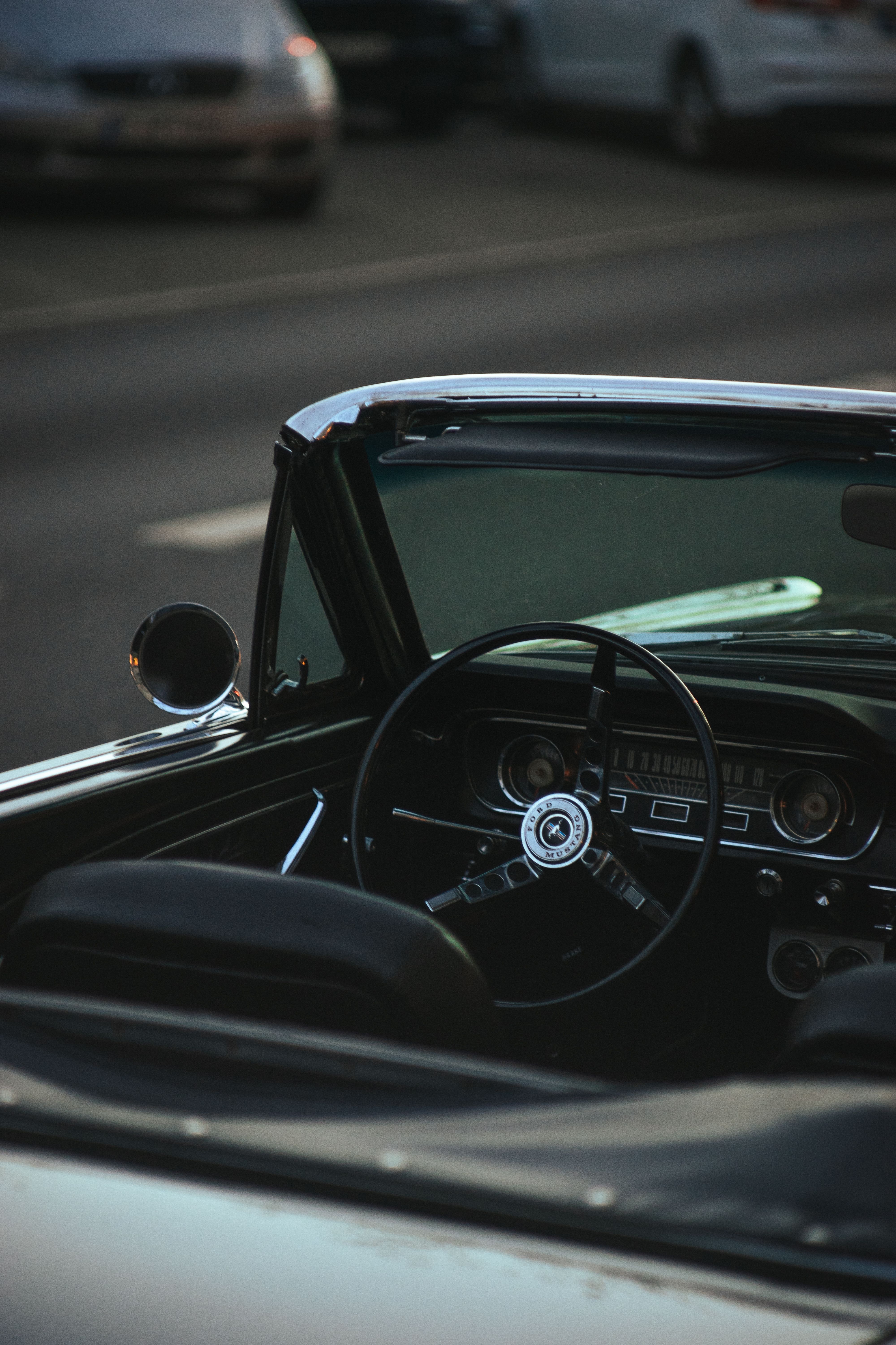Discover the vintage charm of a classic convertible's interior captured at sunset.
