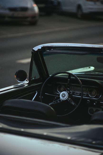 Discover the vintage charm of a classic convertible's interior captured at sunset.