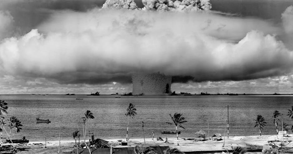 Grayscale Photo of Explosion on the Beach