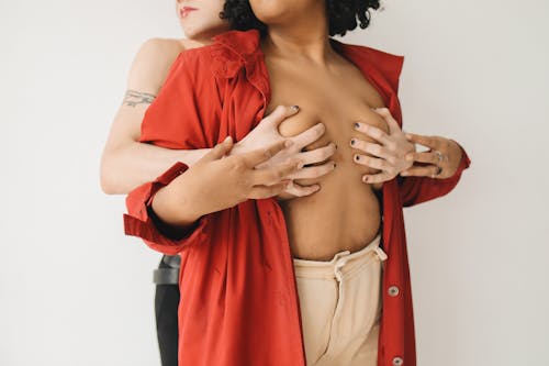 Women Posing Together and One Holding Breast of The Other 