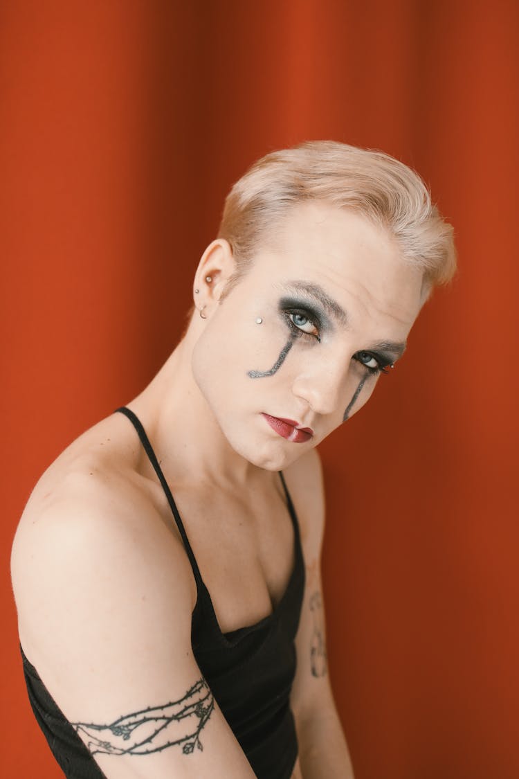 Non Binary Person With Tattoos Wearing Creative Makeup 