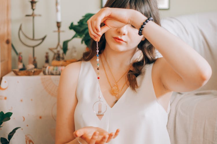 Woman Telling Fortune With Silver Pendant