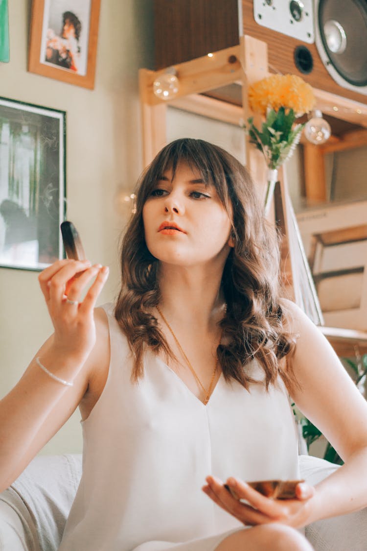 Woman Looking At Burning Wooden Sandal Stick