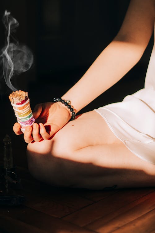 Free Woman with smudge sticks on floor Stock Photo