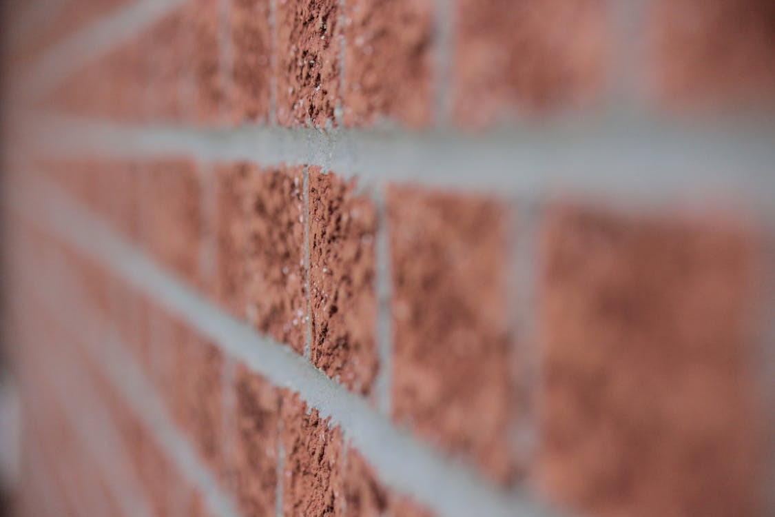 무료 갈색 벽돌 벽을 닫습니다. 스톡 사진
