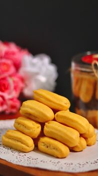 Mouthwatering stack of homemade eclairs on a lace doily, perfect for dessert lovers.