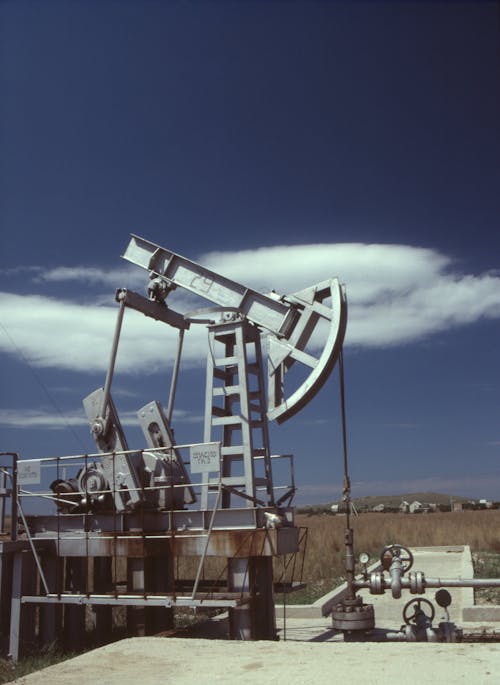 A Gray Steel Pumpjack Under Blue Sky