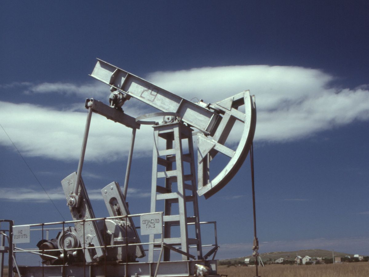 Oil pumpjack operating against a clear blue sky