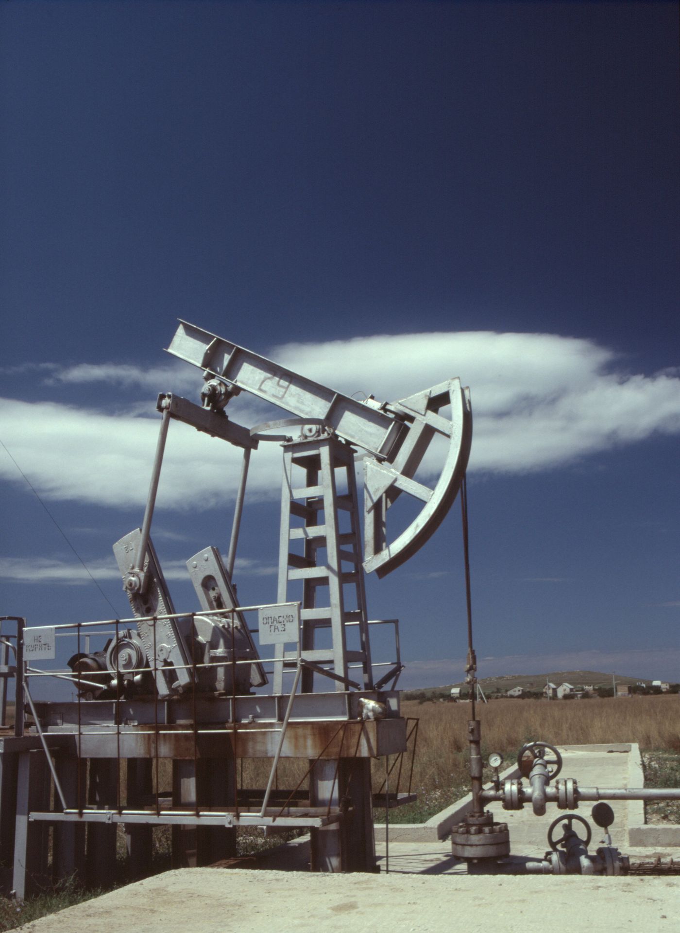 Steel pumpjack under a clear sky