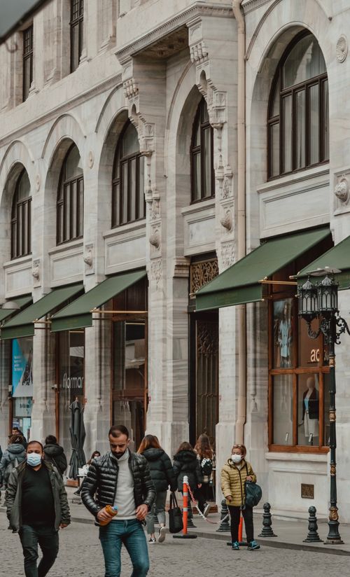 Free A busy street with pedestrians in front of historical architecture. Stock Photo