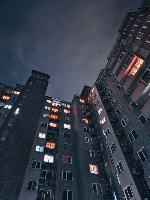 Free Low-angle view of a modern apartment building in Beijing, China, illuminated at night. Stock Photo