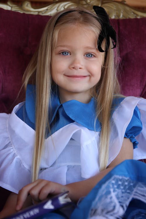 Young Girl in White and Blue Dress Smiling