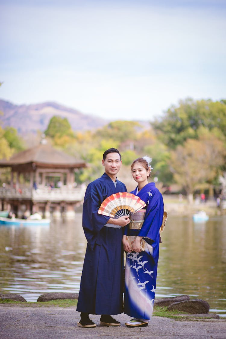 Man Holding A Fan And A Woman