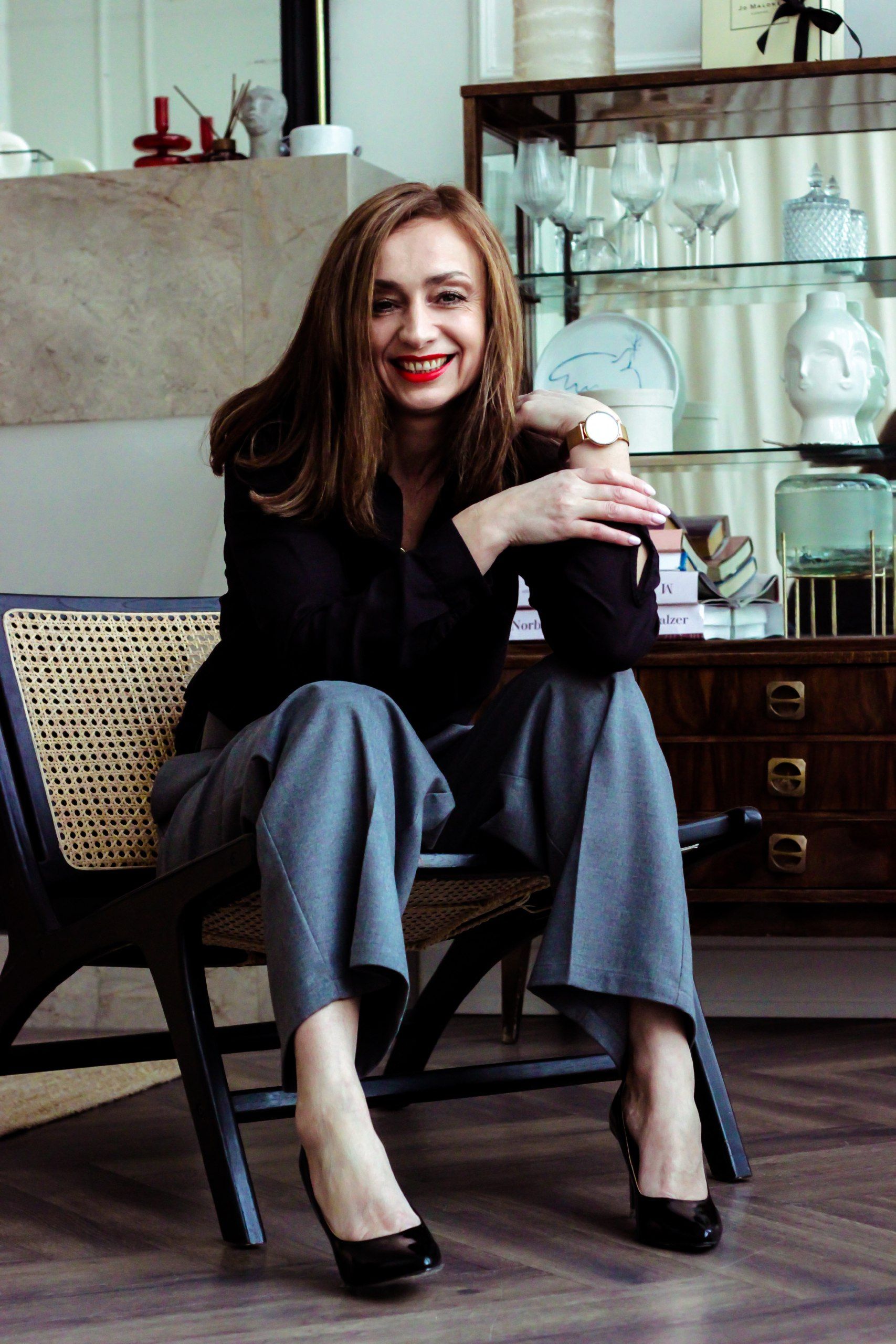 Fashionable woman sitting on a stylish chair in a modern Minsk home interior.