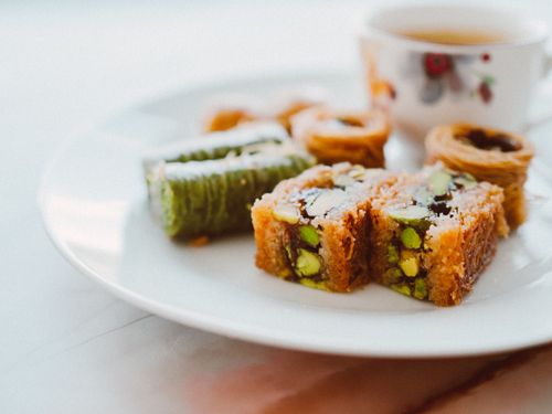 Free Tasty assorted baklava with tea, perfect for festive celebrations and sweet indulgence. Stock Photo