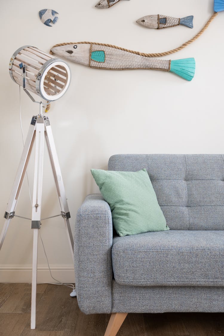 Comfy Couch Near Decorated Wall In Creative Apartment