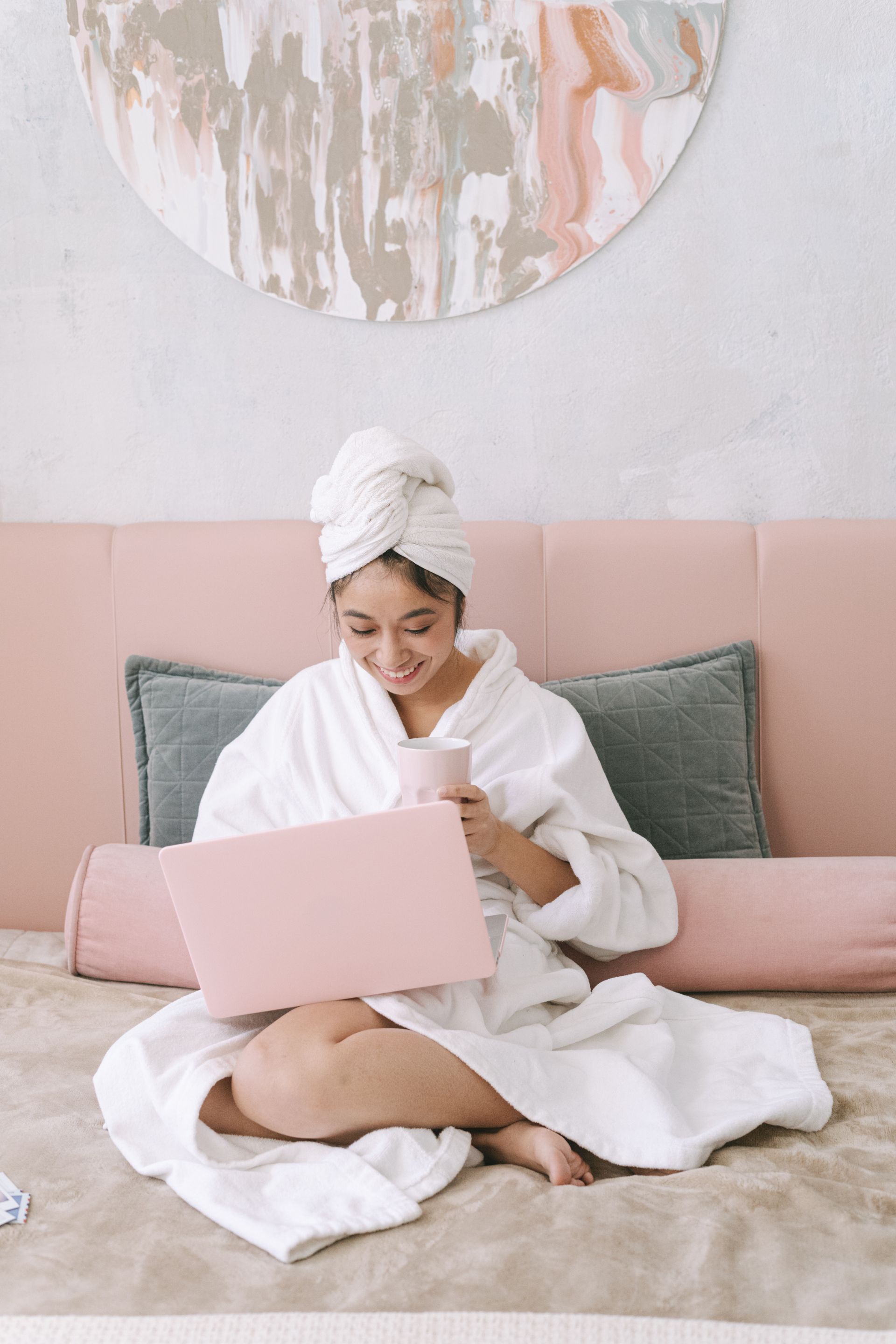 Guest working on a laptop in a bright Kestrel Harbor Inn suite
