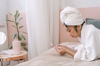 Woman in White Hijab Holding Smartphone