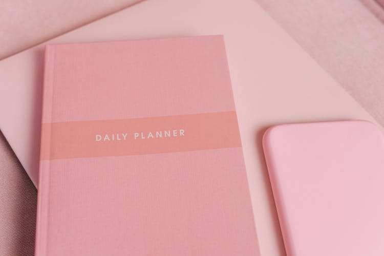 A Pink Planner On The Table