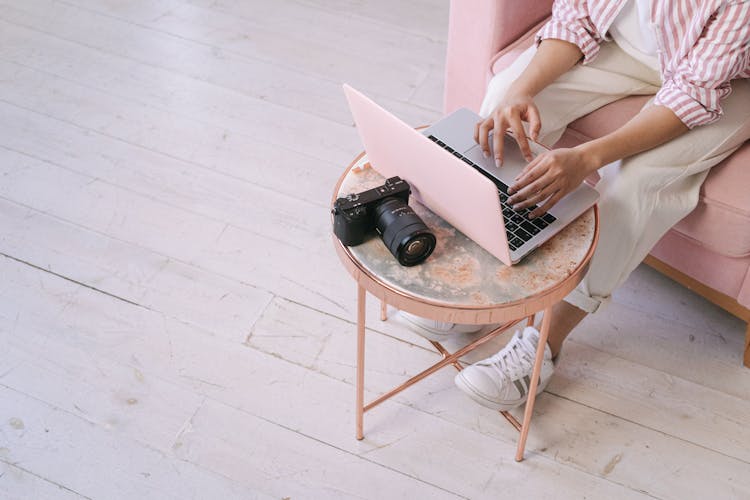 A Person Using A Laptop At Home