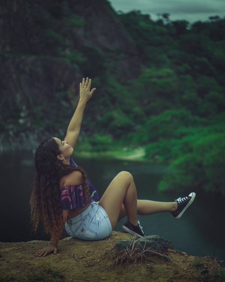 Photo Of A Woman In Denim Shorts Raising Her Arm