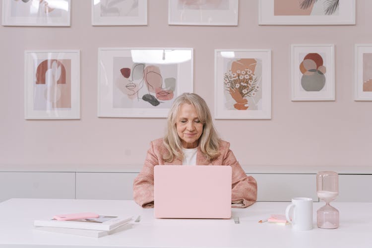 An Elderly Woman Using A Laptop