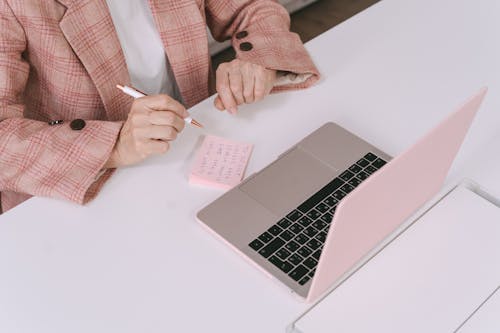 Free Person Sitting in Front of a Macbook  Stock Photo