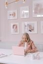 Adult Woman Sitting In Front of a Laptop