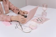 Person Using Macbook on Table