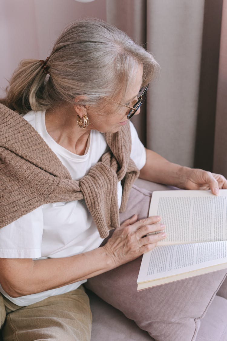 Photo Of An Elderly Woman Reading A Book