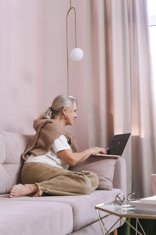 Free A Woman Sitting on the Couch Stock Photo