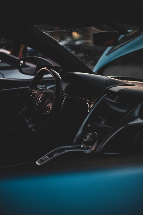 Free Stylish view of sleek car interior with focus on steering wheel and dashboard. Stock Photo