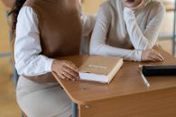 Woman in White Long Sleeve Shirt Holding White Tablet Computer