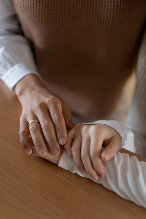 Free Close-up of two hands gently touching, creating a sense of connection and warmth. Stock Photo