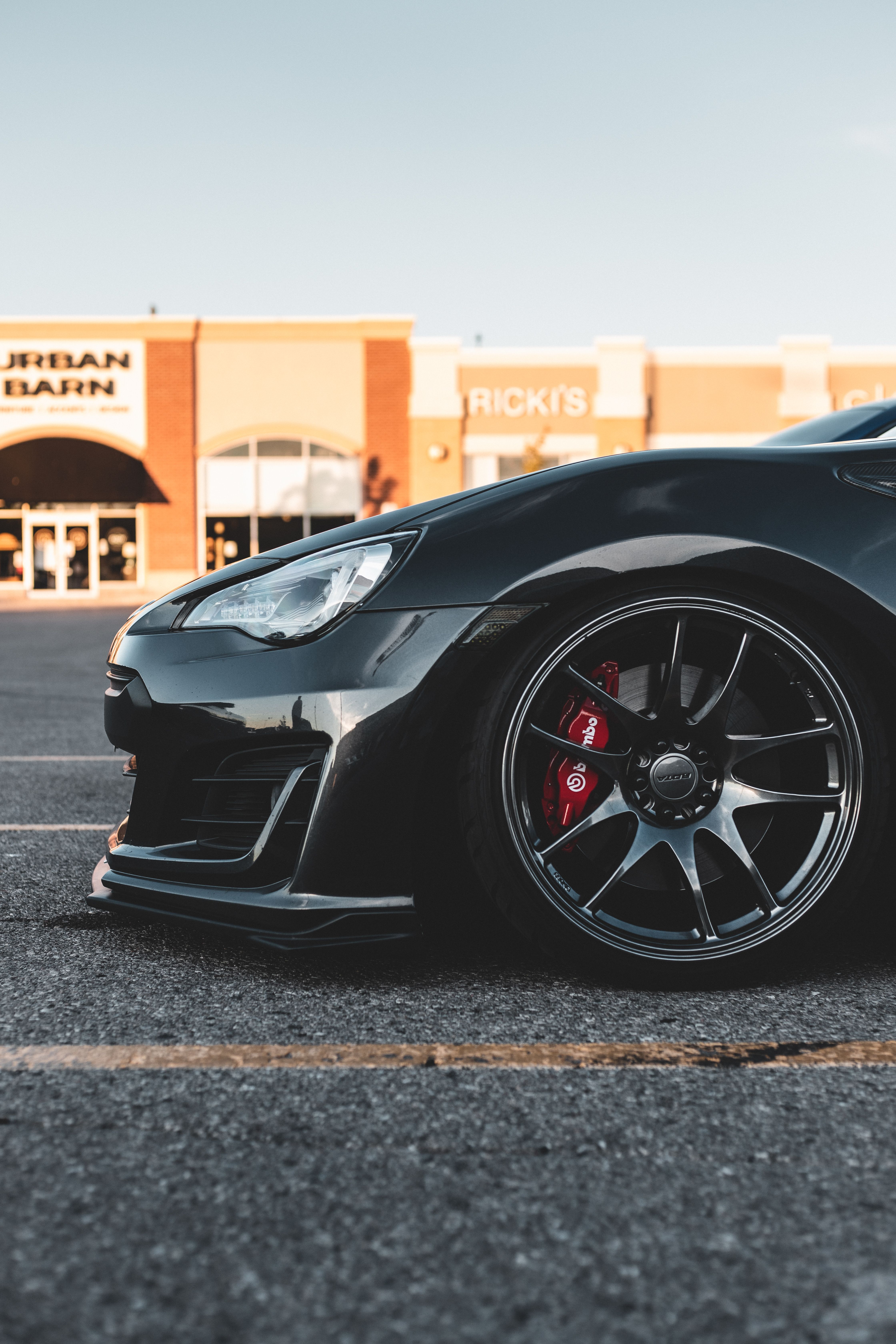 Black Wheel of a Black Car in the Parking Lot · Free Stock Photo