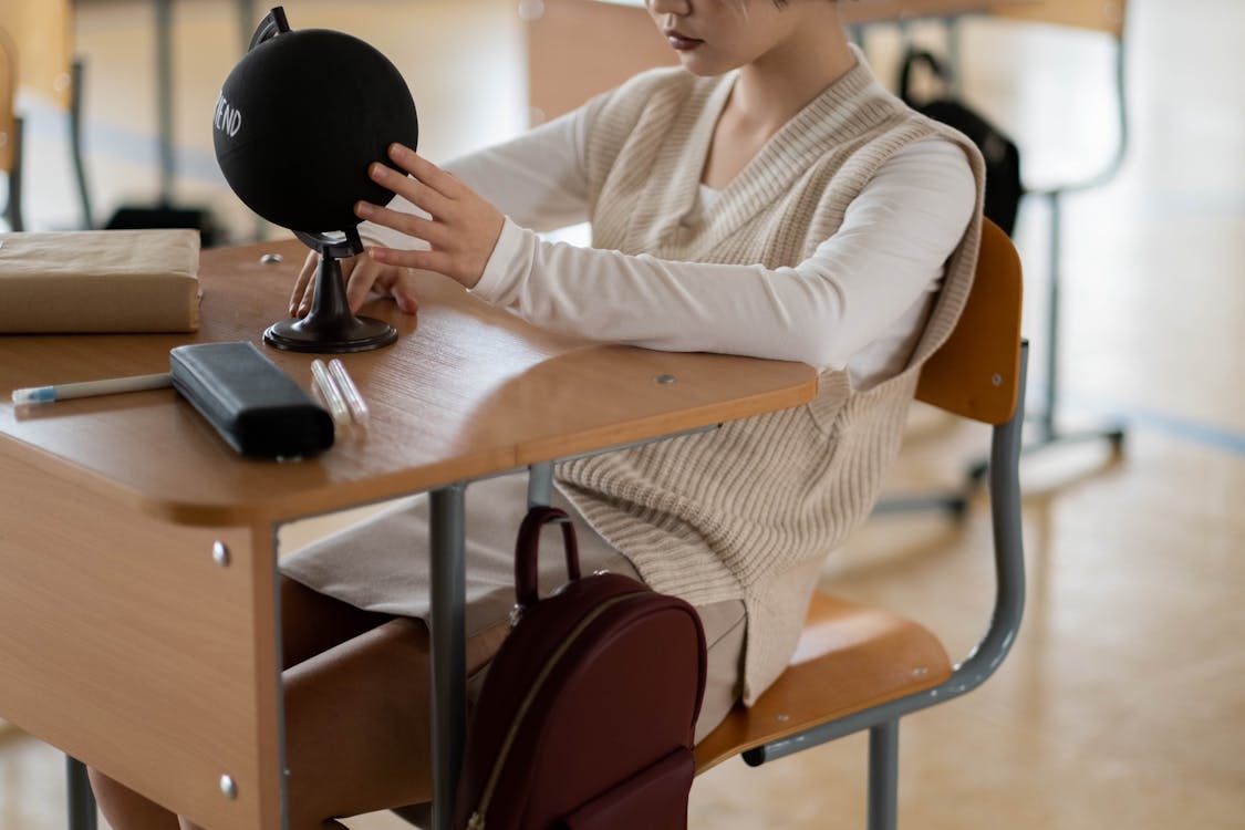 Free Woman in White Sweater Sitting on Chair Stock Photo