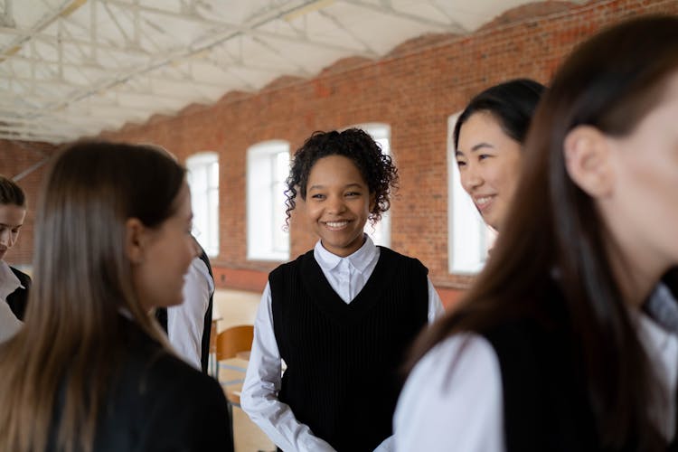 A Group Of Students Talking To Each Other 