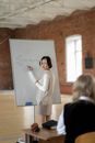 Woman in White Long Sleeve Shirt Holding White Printer Paper