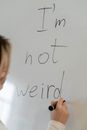 Boy Writing on White Board