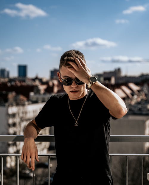 A Man in Black Crew Neck Shirt Wearing Sunglasses