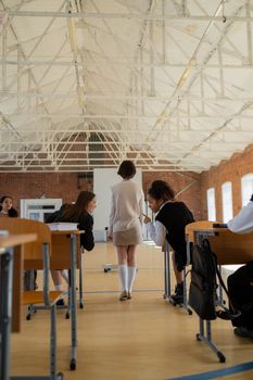 Students in a spacious classroom with a focus on social interactions and academic environment.