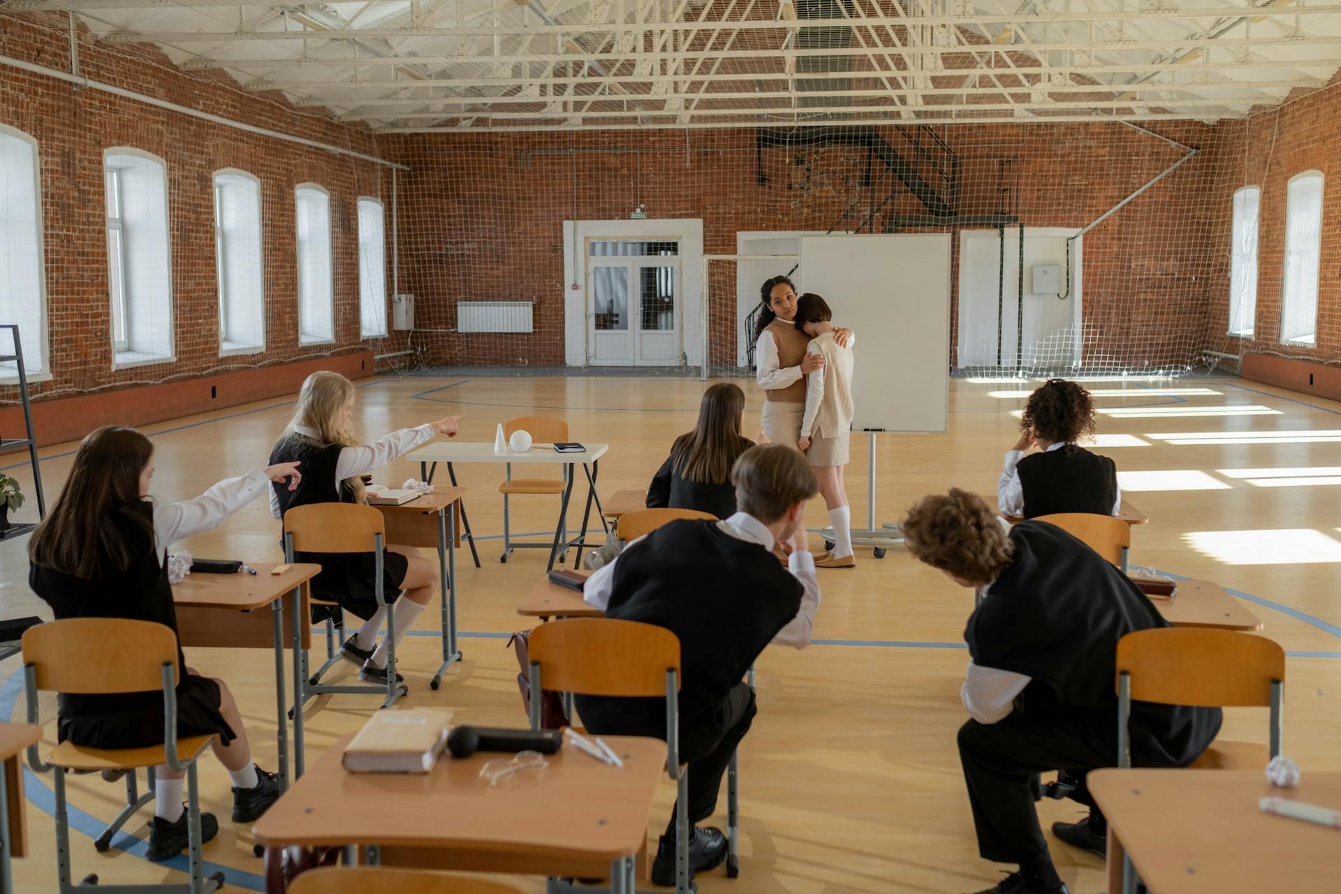 A Teacher Hugging a Student Being Bullied in a Classroom