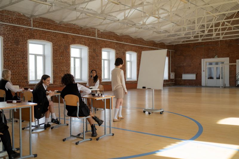 Students in uniform during a lesson with a teacher