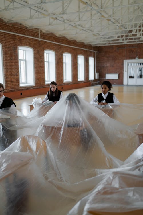 A Student Covered in Plastic Sheet