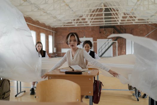 Students in a classroom setting with unique plastic decor, adding an artistic touch.