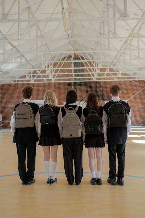 Free Back View of a Group of Students Wearing Backpacks Stock Photo