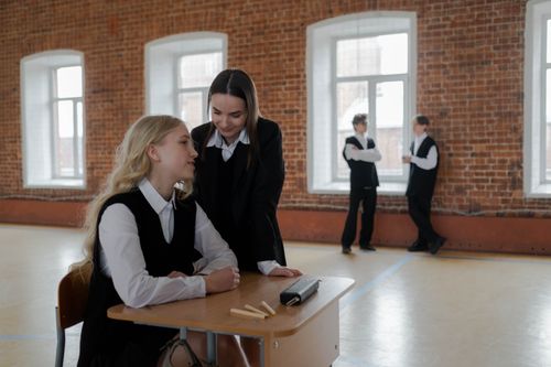 Free Students in a classroom setting discussing topics, highlighting the educational environment. Stock Photo