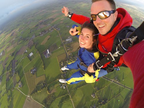 Woman and Man Wearing Overalls Sky Diving