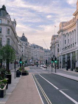 Exterior of calm street of aged European city with classic architecture of facades and green trees